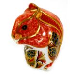A Royal Crown Derby porcelain red squirrel paperweight, red printed marks and gold stopper, 9cm