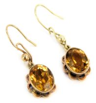 A pair of 9ct gold citrine drop earrings, each formed as a floral cluster with rub over central