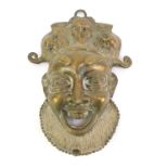 A bronze Bamum wall mask, depicting a figure wearing headdress, with mouth open, 26cm high.