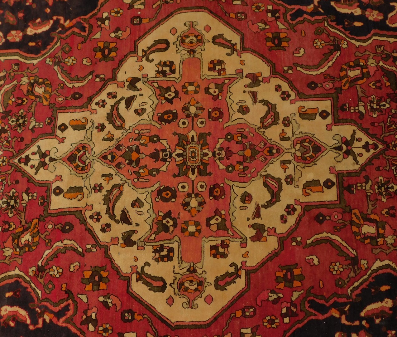 A Persian red ground rug, decorated centrally with flowers within one wide and two narrow borders, - Image 2 of 4