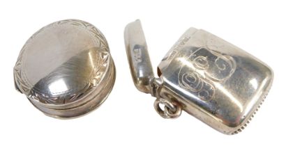 An Edward VII silver Vesta case, of curved plain form, monogram engraved, Chester 1902, and an