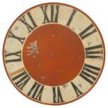 A large painted industrial clock face, of circular form, with raised Roman numeric characters,