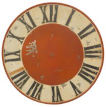 A large painted industrial clock face, of circular form, with raised Roman numeric characters,
