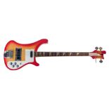 A Rirkenbacker electric bass guitar, the body in red, with the front panel fading to a yellow, the