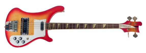 A Rirkenbacker electric bass guitar, the body in red, with the front panel fading to a yellow, the