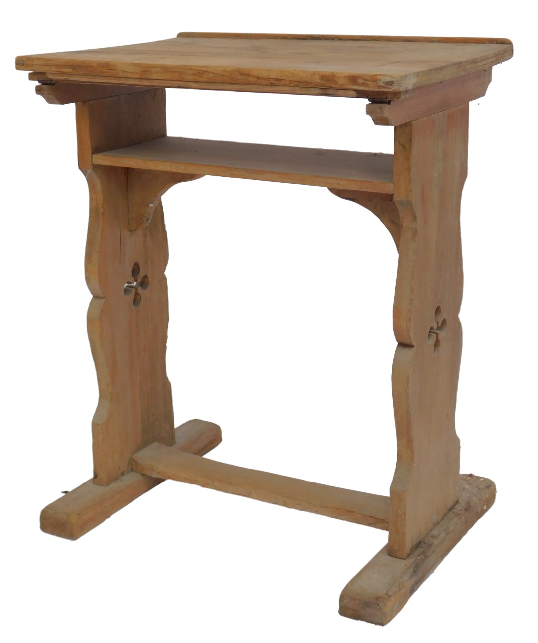 A pine lectern, the rectangular top, strut support with under tier, raised on two carved and pierced