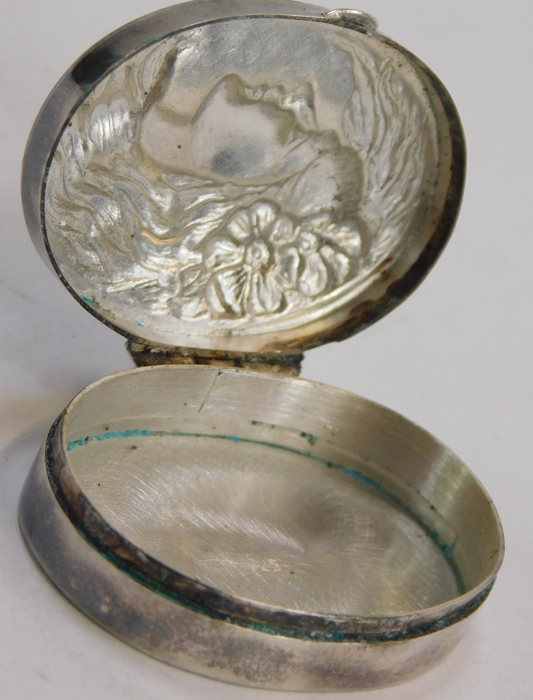 A silver pill box, the oval pill box with hammered decoration of a female with flowing hair and - Image 2 of 3