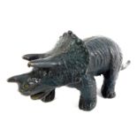 A patinated brass figure, modelled as a triceratops, 17cm long.