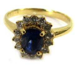 A sapphire and diamond dress ring, set with central oval sapphire approx 0.84ct, in four claw