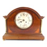 An early 20thC mahogany and inlaid mantel clock, the circular silvered dial bearing Arabic numerals,
