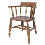 A 20thC elm captain's type chair, with solid rail, arms, tuned support, solid seat, on turned legs