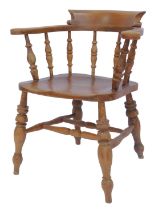 A 20thC elm captain's type chair, with solid rail, arms, tuned support, solid seat, on turned legs