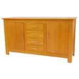 A contemporary oak sideboard, the rectangular top above four central doors flanked by two cupboards,