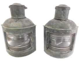 A pair of early 20thC cast metal ship's lanterns, port and starboard, with ring handles, 33cm high.