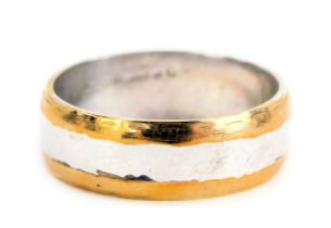 A bicolour wedding band, with yellow and white gold finish, with rubbed marks, possibly 9ct, ring