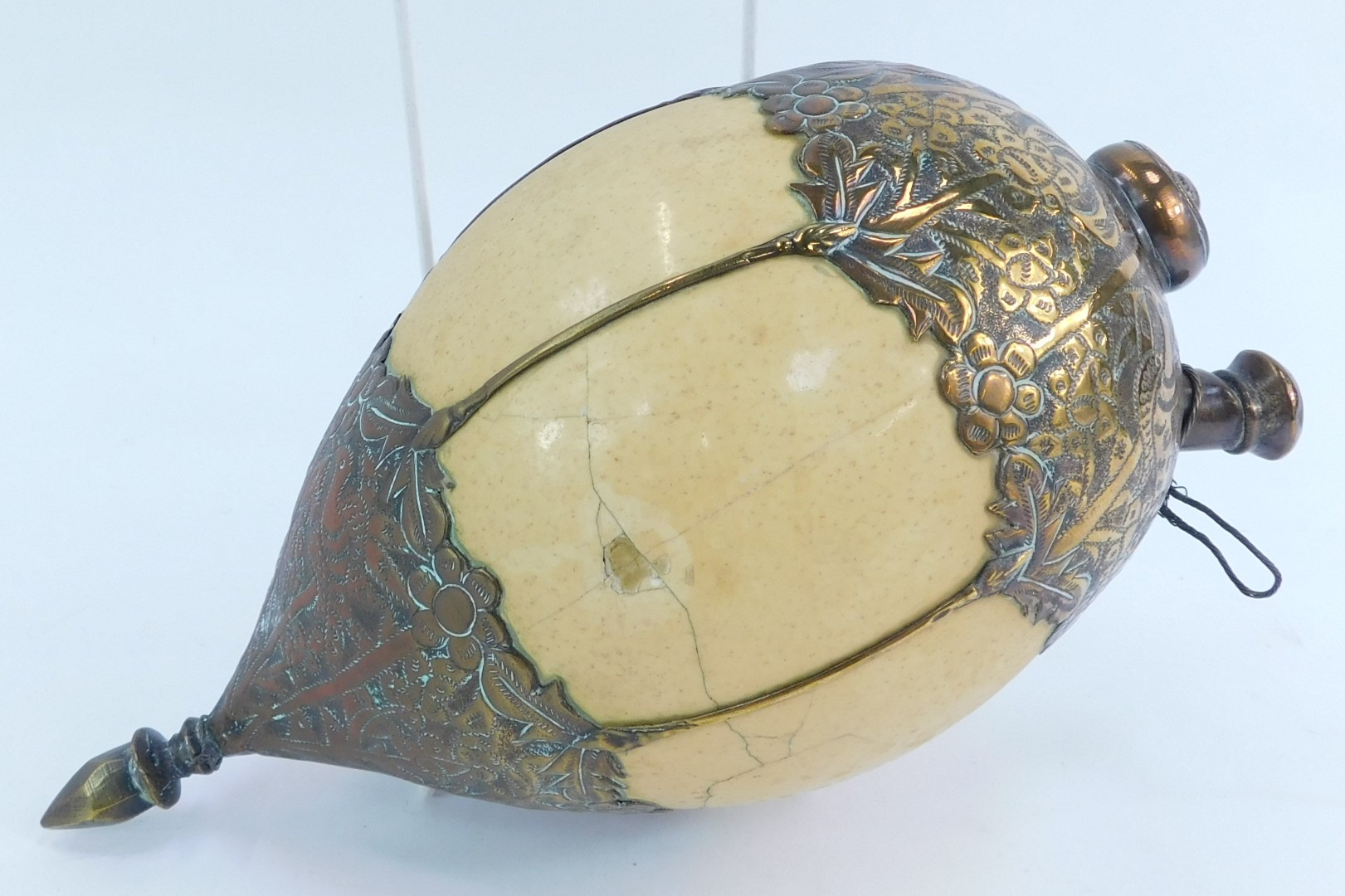 A Middle Eastern ostrich egg drinking vessel, with brass mounts to top and base, decorated with - Image 2 of 3