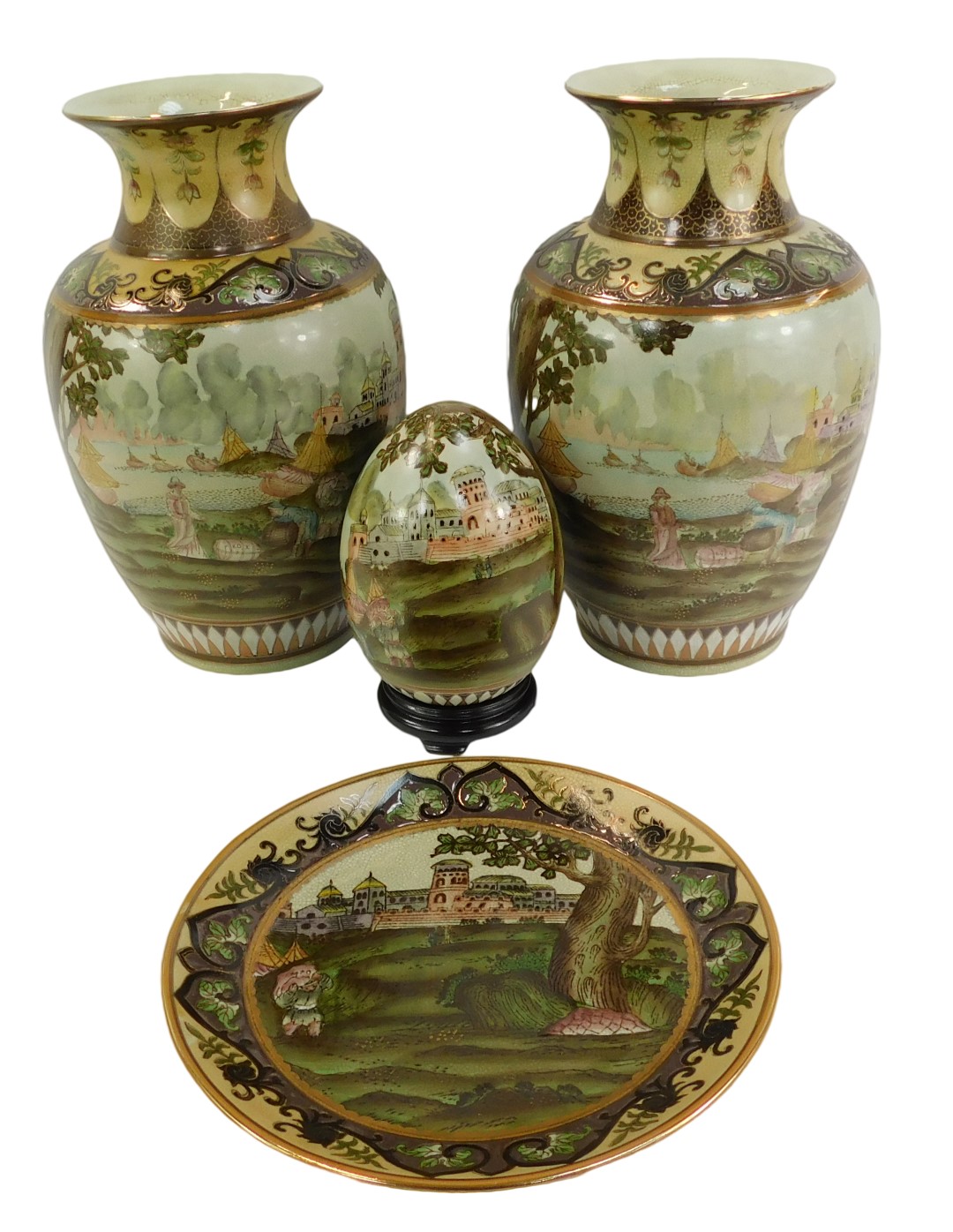A pair of Oriental ceramic vases, each decorated with figures before river and buildings,