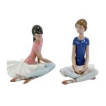 Two Lladro porcelain figures, each modelled as a seated ballerina, printed marks, 21.5cm and 18cm