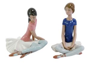 Two Lladro porcelain figures, each modelled as a seated ballerina, printed marks, 21.5cm and 18cm