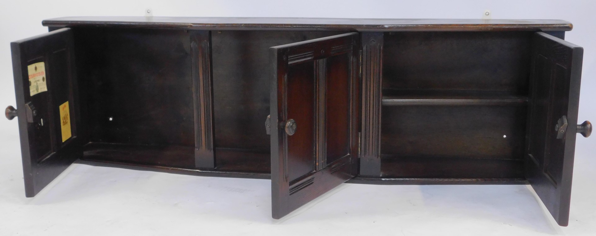 A 20thC oak Ercol style hanging bow fronted wall cabinet, with three fielded panelled doors, 39cm - Image 3 of 6