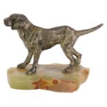 A 1960s/1970s model of a dog, on an onyx base, the dog with a silvered finish, 12cm high, 13cm wide.