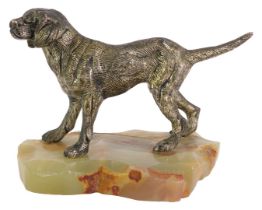 A 1960s/1970s model of a dog, on an onyx base, the dog with a silvered finish, 12cm high, 13cm wide.