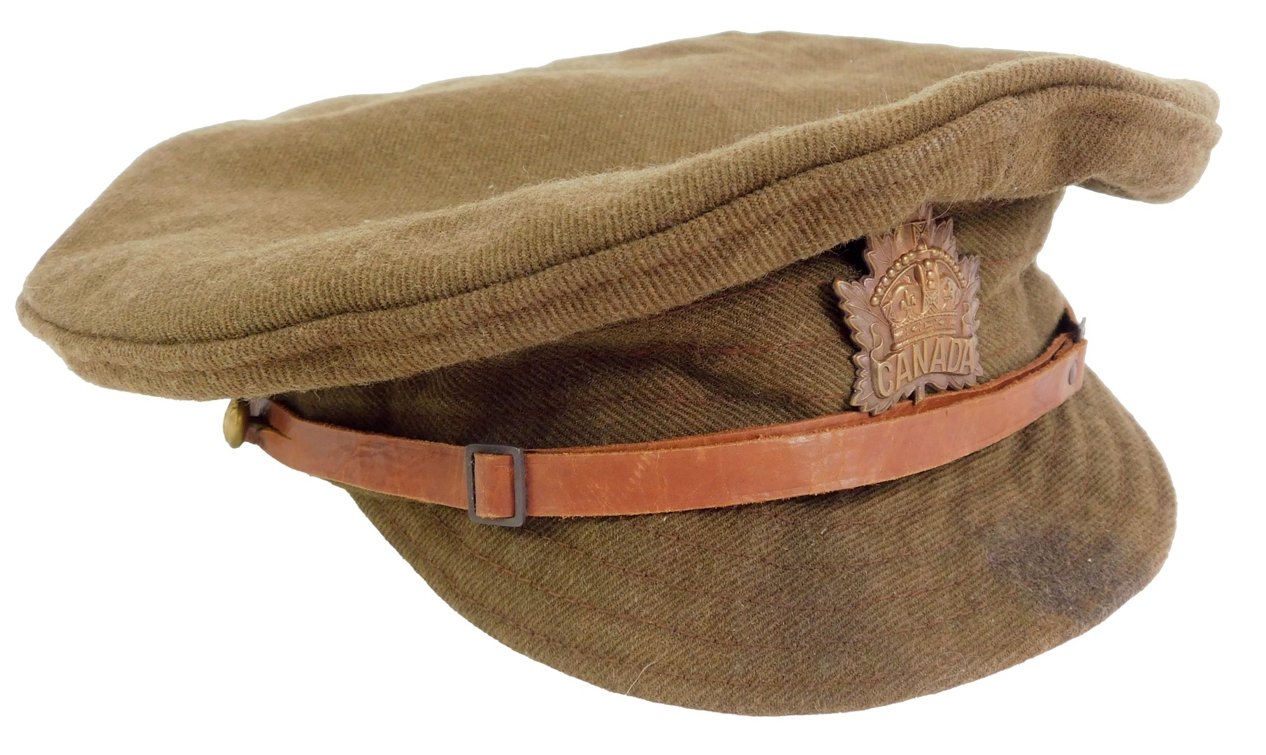 A WWI Canadian army peak cap, dated 1916, with leather adjusting belt and Canada cap badge, 22cm