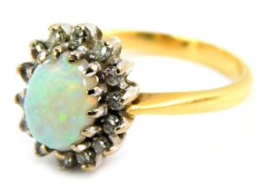 An opal and diamond dress ring, the oval opal in claw setting, approx 0.5ct, surrounded by tiny