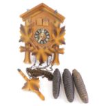 A 20thC pine cased cuckoo clock, with applied maple leaf vines, Regula movement, weights and