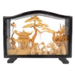 A Chinese carved cork picture, depicting storks before pagodas, with trees, in a black frame, 14.5cm