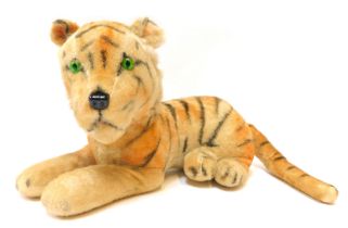 A Steiff mohair recumbent tiger . (AF)