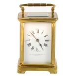 An early 20thC brass cased carriage clock, the square white enamel dial bearing Roman numerals,