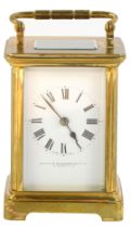 An early 20thC brass cased carriage clock, the square white enamel dial bearing Roman numerals,