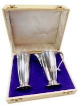 An Elizabeth II silver milk jug and sugar caster set, with a serpent moulded handle and Celtic
