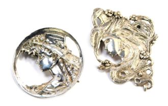 Two Art Nouveau brooches, each depicting figures of females with flowing flowers, one 6cm x 4cm,