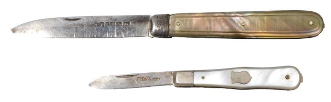 Two mother of pearl handled and silver penknives, one bearing crest, 5.5cm long, and the other 8cm