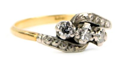 A diamond twist ring, set with three tiny diamonds, each in claw illusion setting, on platinum twist