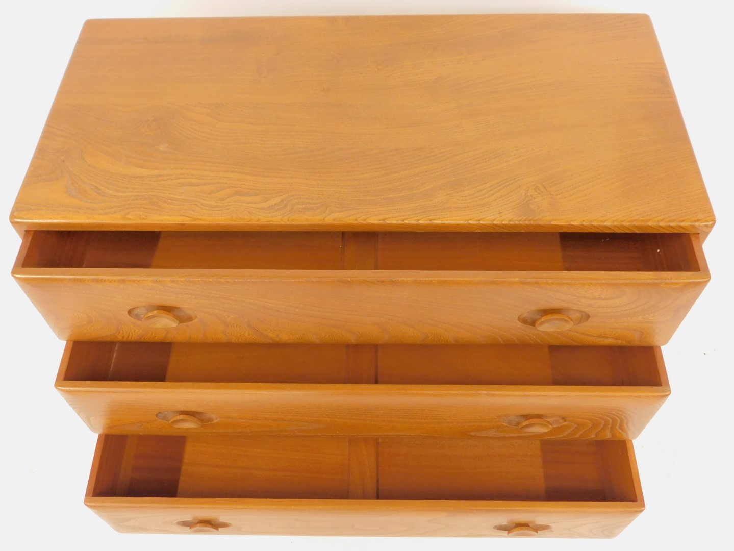 An Ercol elm chest, of three drawers, on castors, model number 412, bearing label, 66cm high, 92cm - Image 2 of 3