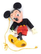 A 20thC Mickey Mouse wooden puppet, with fabric clothing, 27cm high. (AF)