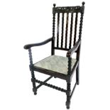 An early 20thC oak carver chair in Carolean style, with scroll and floral carved rail, waved