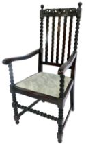 An early 20thC oak carver chair in Carolean style, with scroll and floral carved rail, waved