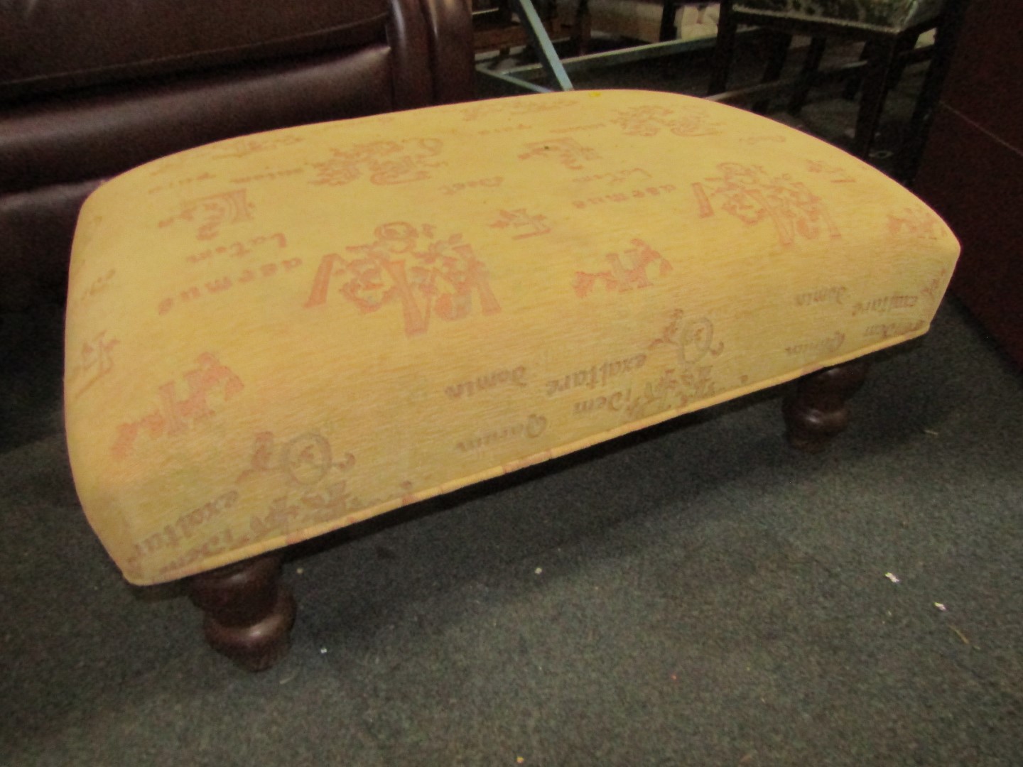 A gold damask footstool, on pine carved legs.