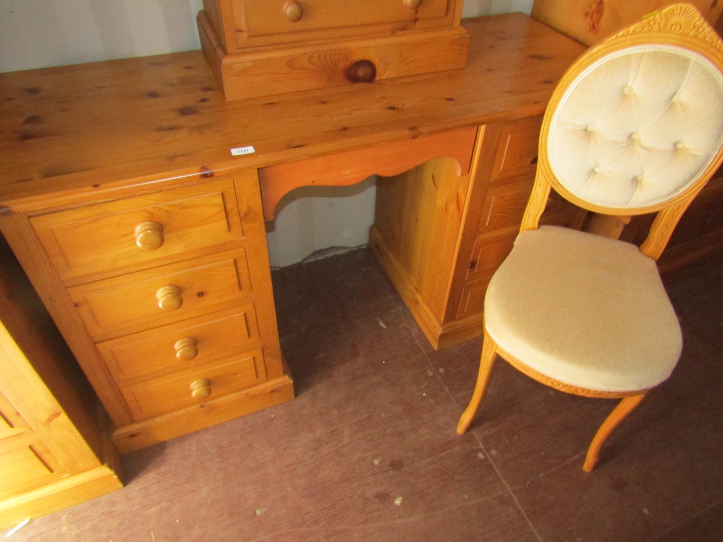 A pine dressing table, with four drawers to each side and associated chair.