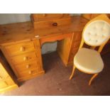 A pine dressing table, with four drawers to each side and associated chair.