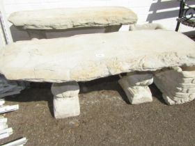 A reconstituted stone garden bench, on two squirrel supports, 43cm high, 99cm wide, 37cm deep.