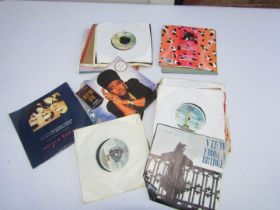 A group of 45rpm records, including rock and pop, Laura Brannaghan, The Beatles Hits, Prince