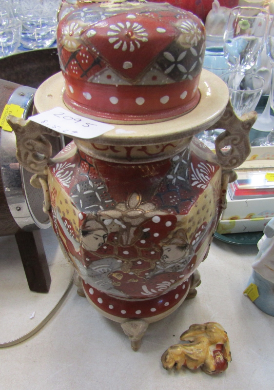 A Japanese Satsuma jar and cover, red ground with dogs of fo, 23cm high. (AF)