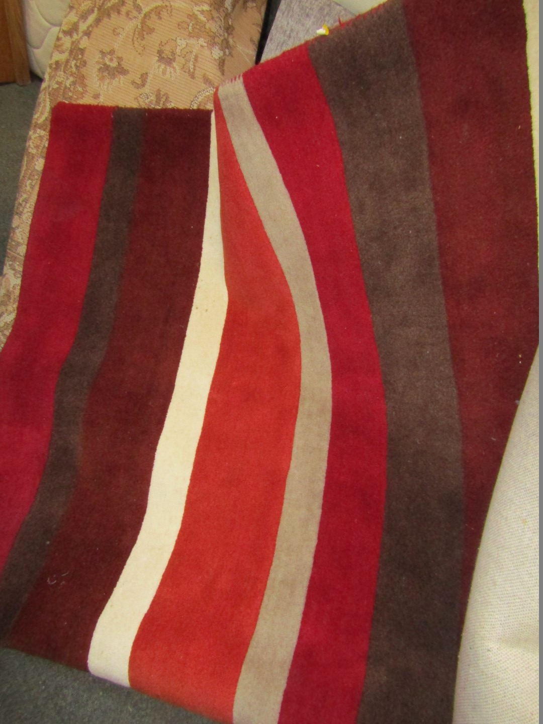 A wool cut rug, with red border.