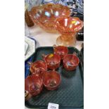 Various carnival glass, comprising carnival glass punch bowl, six glasses, raised pedestal bowl. (