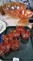 Various carnival glass, comprising carnival glass punch bowl, six glasses, raised pedestal bowl. (